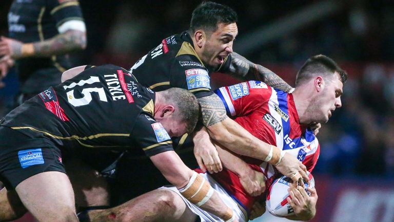 Wakefield's Joe Arundel is tackled by Leigh's Danny Tickle and Harrison Hansen