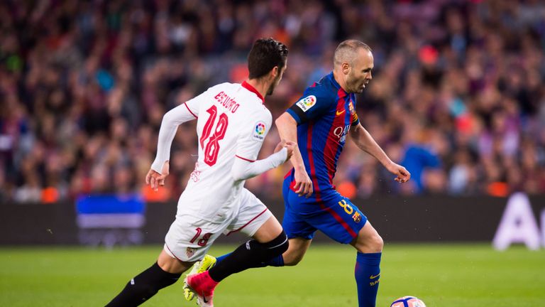 Andres Iniesta (right) and Sergio Escudero tussle for the ball