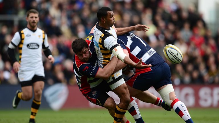 Kurtley Beale offloads the ball in the tackle against Bristol