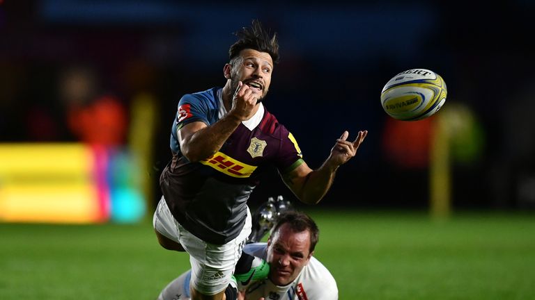 Danny Care of Harlequins offloads as he is tackled by Kai Horstmann of Exeter Chiefs 