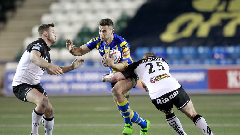 Widnes' Alex Gerrard and Tom Olbison tackle Warrington's Toby King