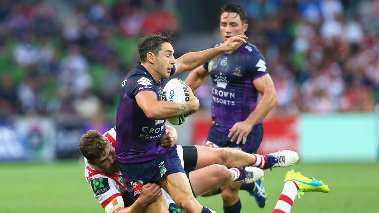 Billy Slater of the Storm is tackled by Gareth Widdop and Will Matthews of the Dragons
