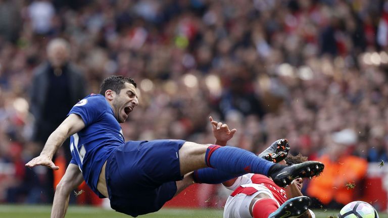 Henrikh Mkhitaryan is challenged by Alex Oxlade-Chamberlain