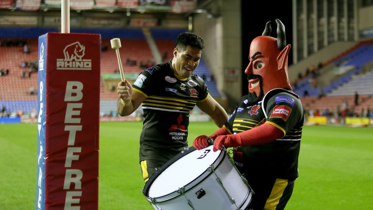 Salford's Lama Tasi celebrates with the Salford mascot after the win