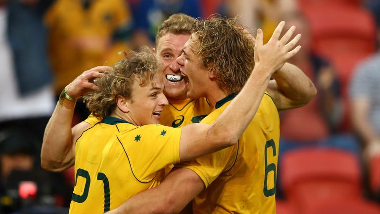 Reece Hodge of the Wallabies celebrates with team-mates after his try against Italy