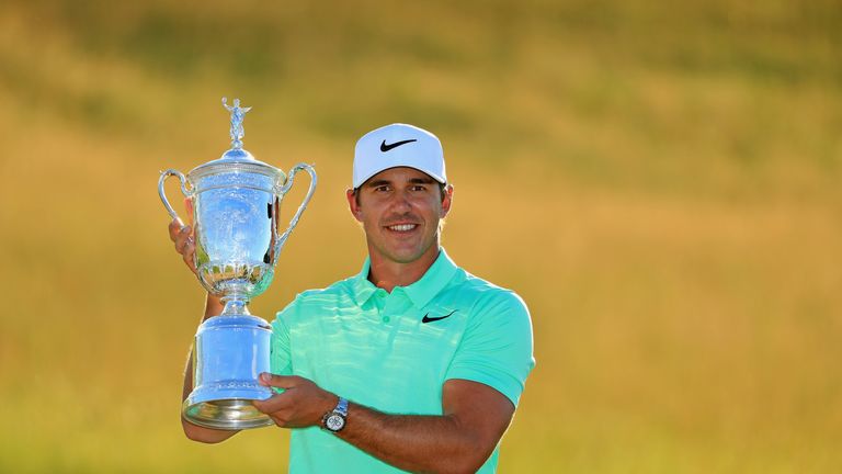 Koepka poses with the trophy after his victory at the US Open