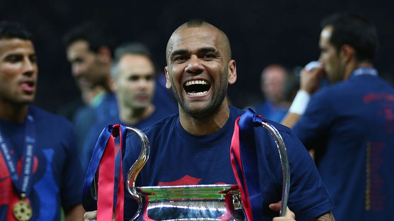 Alves celebrates with the Champions League trophy in 2015