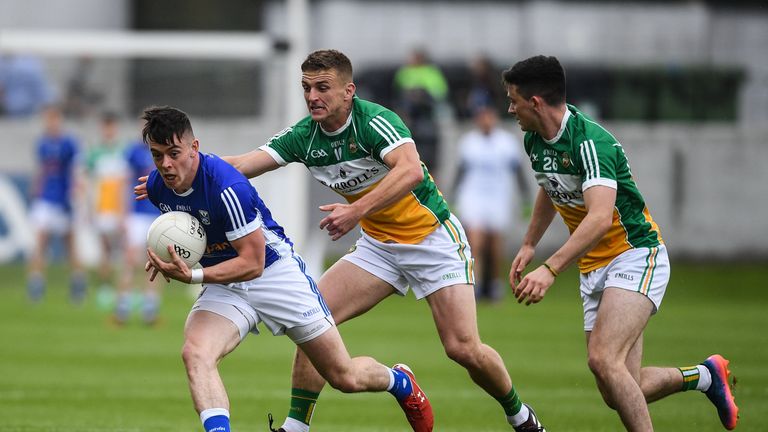 Gerard Smith of Cavan is tackled by Ruairi McNamee, left, and Ruairi Allen of Offaly during the GAA Football All-Ireland Senior Championship Round 1B match