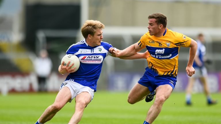 David Conway of Laois is tackled by Clare's Sean Collins