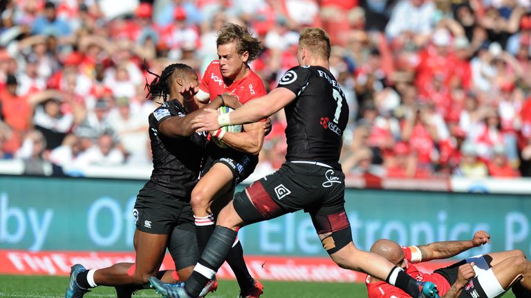 Andries Coetzee is tackled by Sharks pair Sbu Nkosi and Jean-Luc de Preez