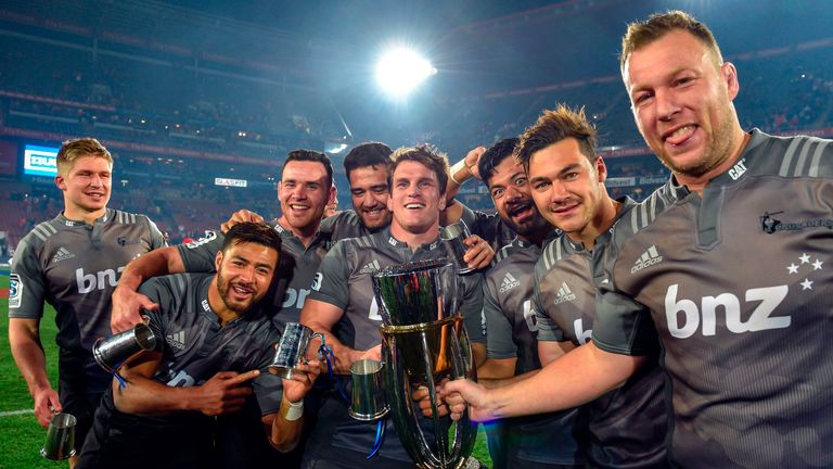Crusaders'rugby team players celebrate with the trophy during the prize ceremony after winning the Super XV rugby final match between Lions and Crusaders a