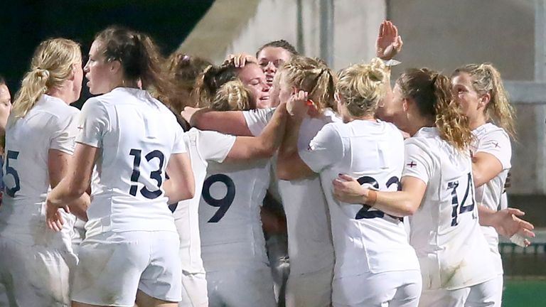 England's players celebrate after Meg Jones' late try confirms their place in the Rugby World Cup final 