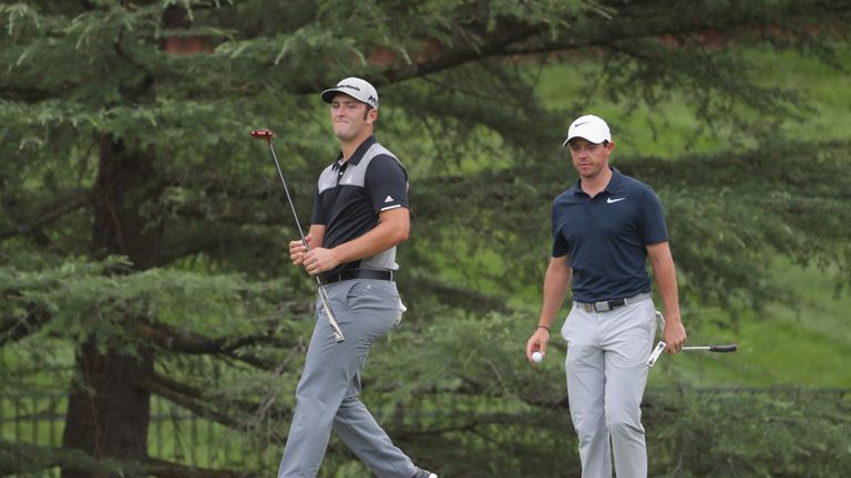 Jon Rahm (left) was in the same threeball as McIlroy 