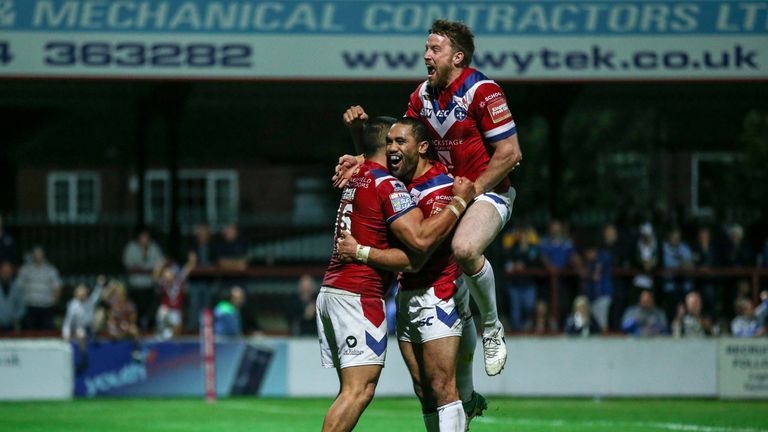 Bill Tupou is congratulated by Tinirau Arona and Danny Kirmond after scoring Wakefield's sixth try