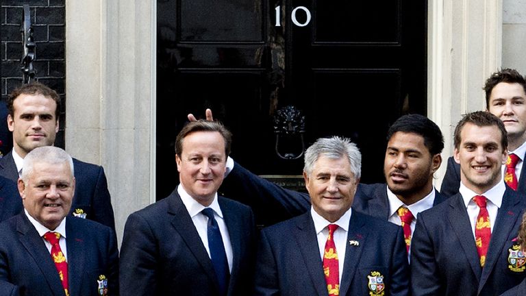 Manu Tuilagi gestures behind the head of British Prime Minister David Cameron in 2013