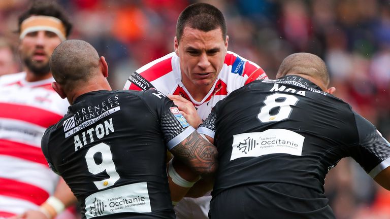 Leigh's Lachlan Burr is tackled by Catalans' Paul Aiton and Sam Moa