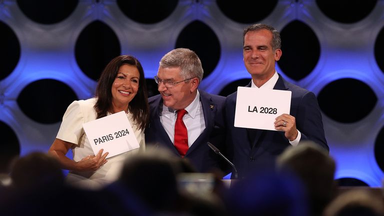 Paris mayor Anne Hidalgo, IOC president Thomas Bach and Los Angeles mayor Eric Garcetti react after confirmation of their successful bids