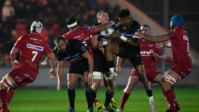 Bath fullback Anthony Watson (3rd r) contests a high ball during the Champions Cup match at Scarlets