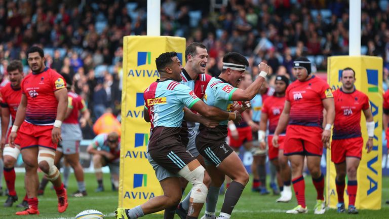 Marcus Smith of Harlequins celebrates scoring a try
