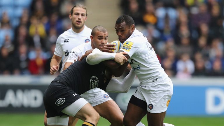  Semesa Rokoduguni is tackled by Elliot Daly