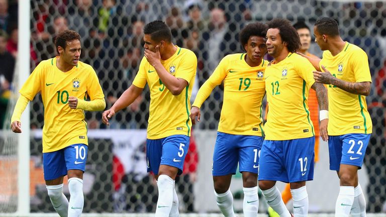 Neymar (left) celebrates with his Brazil team-mates against Japan