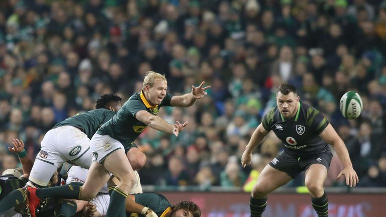 Ross Cronje passes the ball as Cian Healy watches on