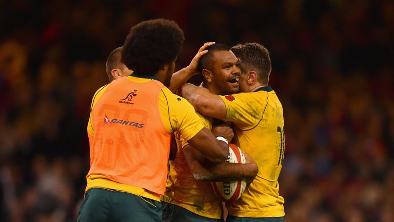 Kurtley Beale is congratulated by team-mates after scoring Australia's fourth try