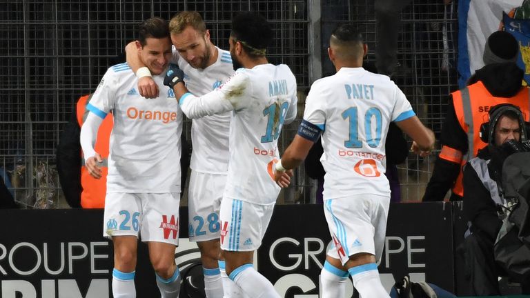 Marseille midfielder Florian Thauvin (L) is congratulated after scoring from the spot against Montpellier