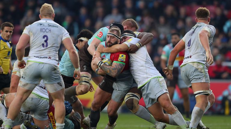 Joe Marler of Harlequins is tackled by fellow England international Jamie George