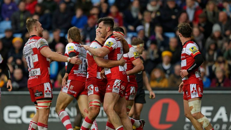 Mark Atkinson of Gloucester celebrates with team-mates after scoring