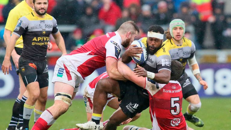 Ulster's Alan O'Connor (L) and Iain Henderson (R) bring down La Rochelle flanker Botia Veivuke (C)