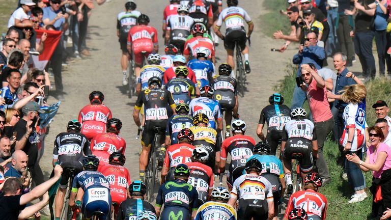 Fans cheer as the pack ride on the cobblestones during the 115th edition of Paris-Roubaix