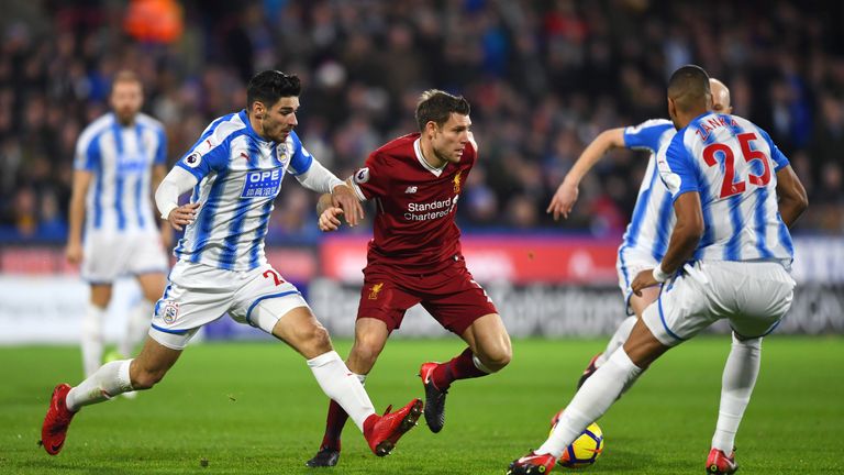 James Milner holds off Christopher Schindler during the Premier League match