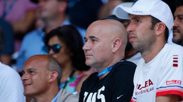 Coaches Agassi (left) and Radek Stepanek watch Djokovic in action against Monfils