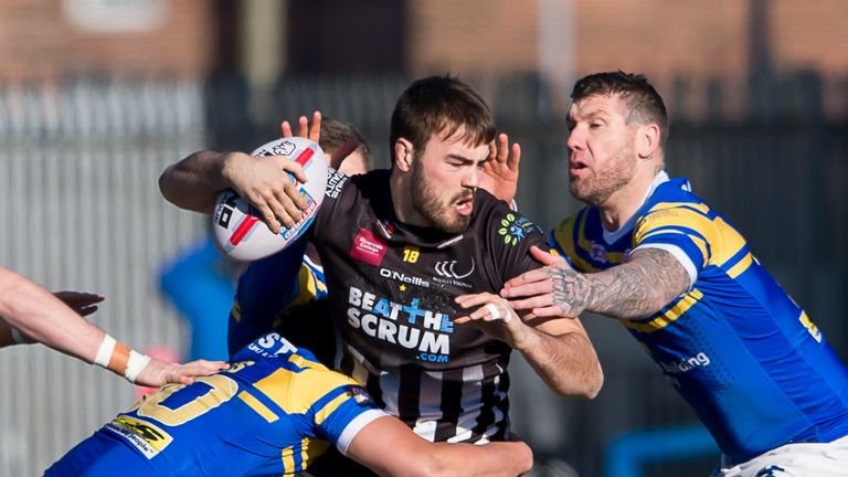 James Chapelhow is tackled by Leeds's Matt Parcell & Brett Delaney.
