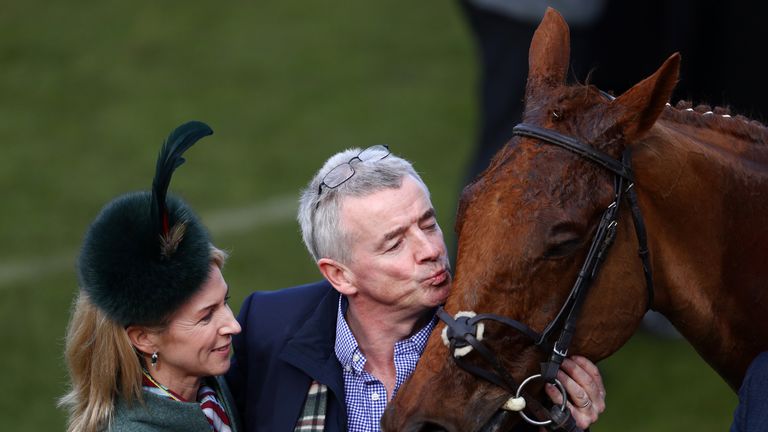Michael O'Leary plants a kiss on the nose of Balko Des Flos after victory in the Ryanair Chase