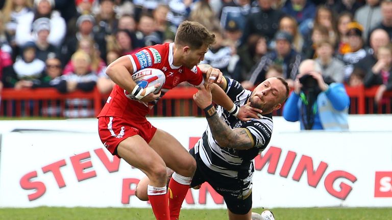 Chris Atkin (L) of Hull KR pushes aside Josh Griffin (R) of Hull FC in their hotly-contested Good Friday encounter