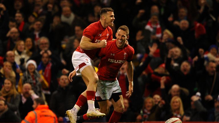 Liam Williams (R) celebrates scoring his side's first try with Gareth Davies 