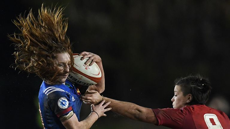 France's scrum-half Pauline Bourdon evades the tackle of Wales' No 8 Sioned Harries