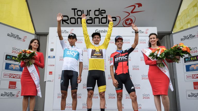 Primoz Roglic (C) celebrates after winning the Tour de Romandie ahead of Egan Bernal (L) and Richie Porte (R)