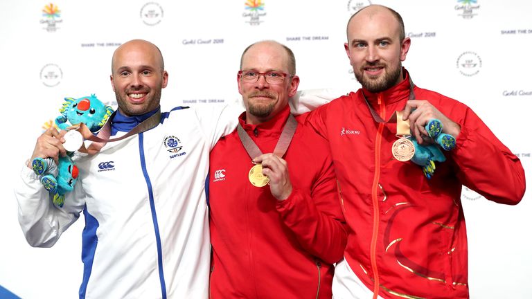 Phelps on the podium with Scotland's Neil Stirton, left, and England's Kenneth Parr, right