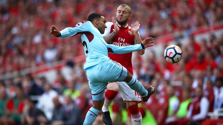 Aaron Lennon collides with Jack Wilshere in the first half