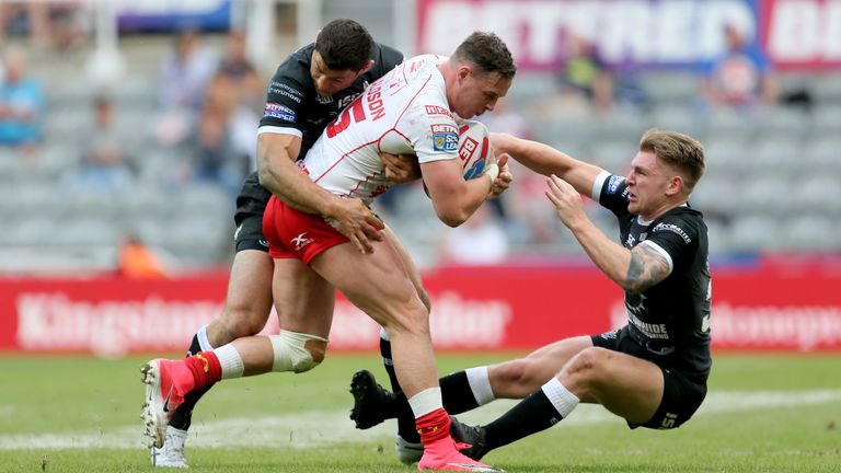 Hull KR's James Donaldson is tackled by Mark Minichiello and Liam Harris