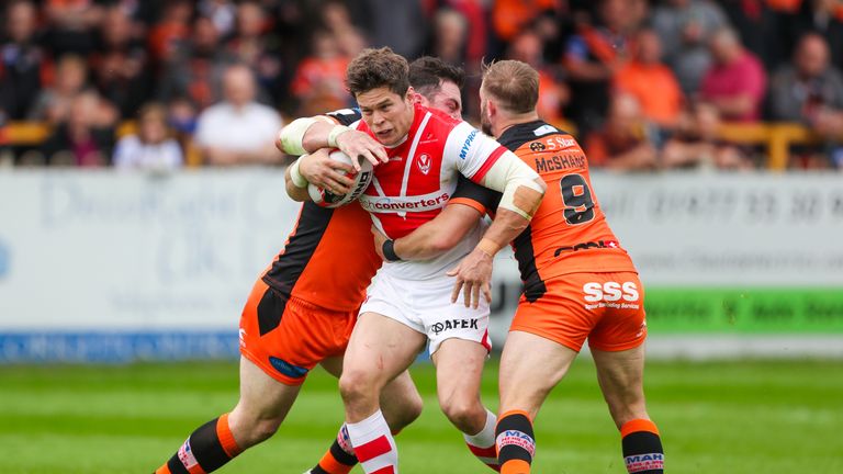 Louie McCarthy Scarsbrook is tackled by Castleford's Paul McShane and Matt Cook.