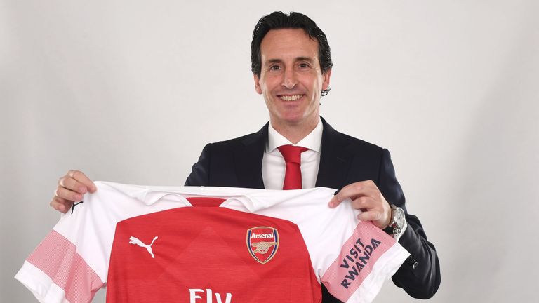 Unai Emery poses at the Emirates with Arsenal's new home shirt for 2018/19