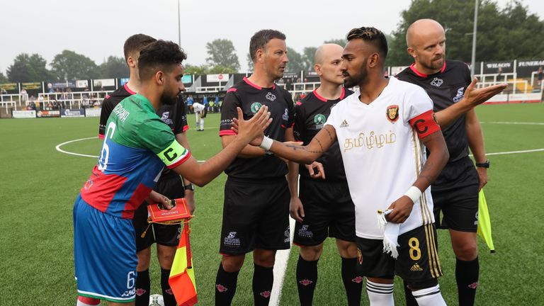 The captains of Barawa and Tamil Eelam shake hands before kick-off at Bromley, watched by referee Mark Clattenburg