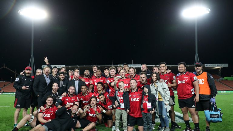 The Crusaders celebrate after Wyatt Crockett (front, flanked by kids) tasted victory on the occasion of his 200th Super Rugby game