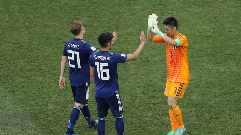 Gotoku Sakai, Hotaru Yamaguchi and Eiji Kawashima celebrate Japan's qualification for the last 16