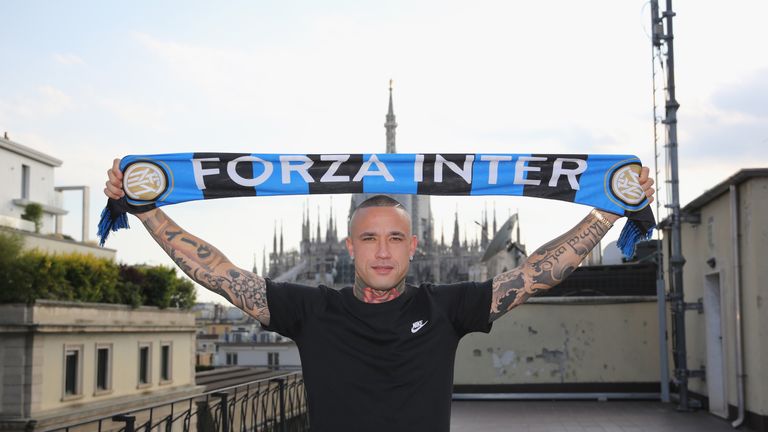 Nainggolan poses for a photograph after signing his contract