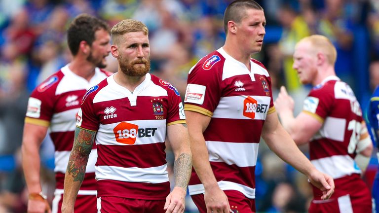 Wigan's Sam Tomkins and co appear dejected after the loss